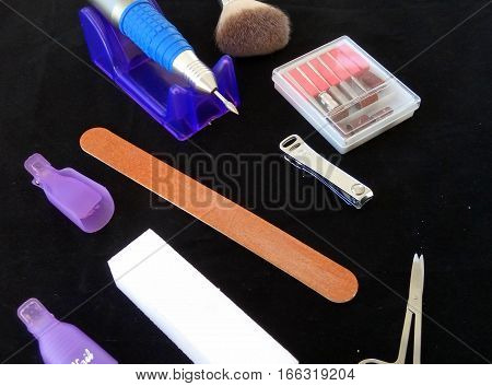 Tools for manicure on a black background accessories in the beauty salon.