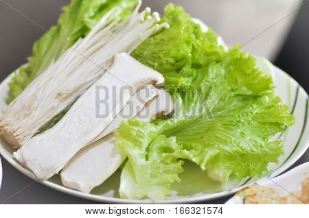 king oyster mushroom golden needle mushroom and lettuce in the dish
