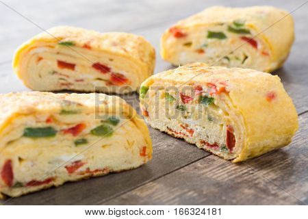 Traditional tamagoyaki Japanese omelette on wooden background