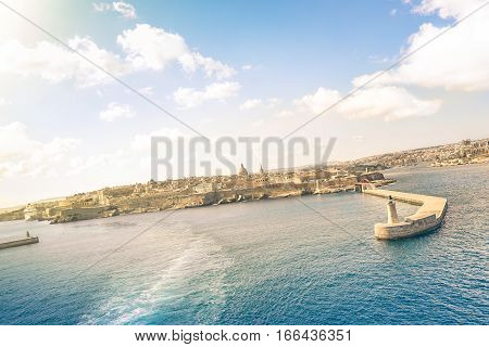 Tilted horizon view of La Valletta before sunset from the sea - Travel and wanderlust concept with capital of world famous mediterranean island of Malta - Wide angle composition with cruise ship track
