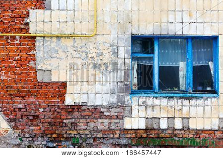 Old Building Falling Apart With Broken Windows, Walls Covered With Cracks And Scratches