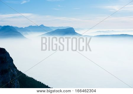 beautiful french alps winter panoramic aerial view landscape with a fantastic blue haze cloudy mountain background