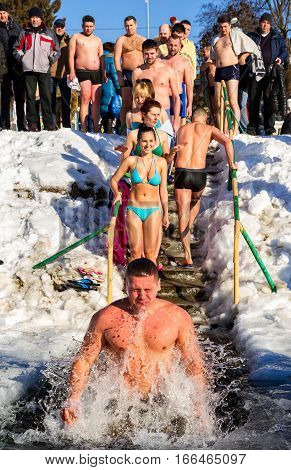Uzhgorod Ukraine - January 19 2017: Greek-Catholic parishioners by orthodox tradition dip in the icy river during the Epiphany celebration. Epiphany Day completes the Christmas-New Year festivities cycle in Ukraine.