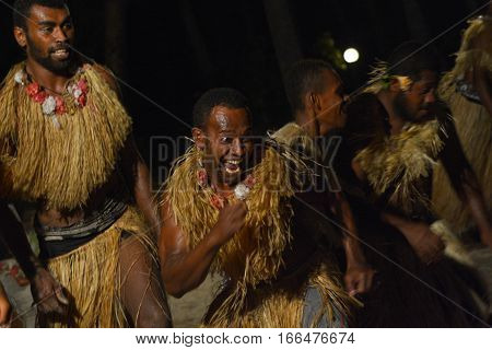 Fijian men dancing a traditional male dance meke wesi the spear dance. Real people copy space