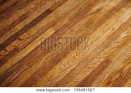 Rich texture of wooden table or floor made of many thin long racks placed horizontally, side view, artisan rustic background