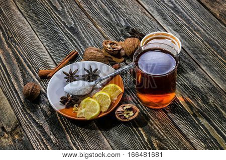 Traditional Scandinavian glogg. A drink with cinnamon and lemon. Dark wood background.
