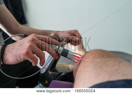 Laser Therapy On A Knee Used To Treat Pain