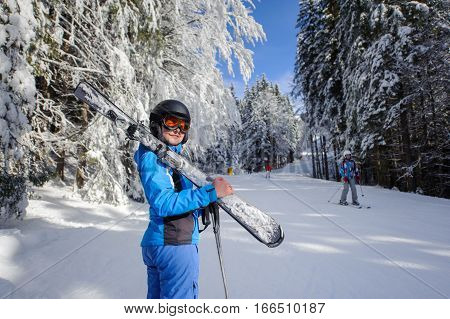 Happy Woman Skier On A Ski Slope In The Forest