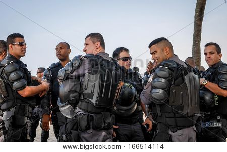 RIO DE JANEIRO BRAZIL - 28 JUNE 2016: A group of Brazilian riot police in their protective armour on patrol on Ipanema Beach.