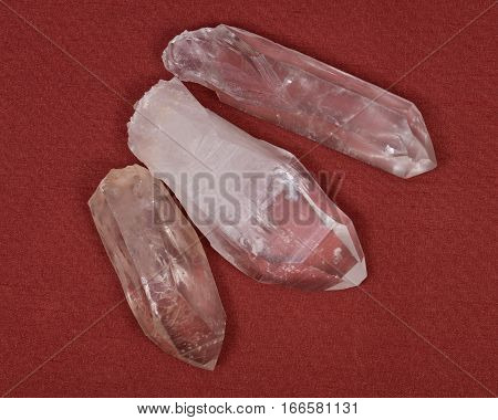 Lemurian Quartz Crystals from Brazil on red fabric background