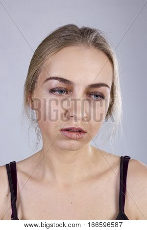 Portrait of a young woman in a gloom on the gray background. Seven Deadly Sins