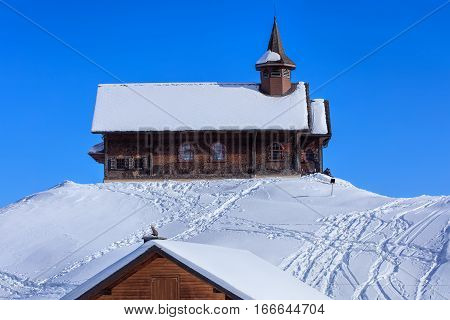 Stoos, Switzerland - 24 January, 2017: wooden chapel covered by snow. Stoos is a village located in the municipality of Morschach in the Swiss canton of Schwyz. It lies at 1300 meters above sea level and has a population of about 100 inhabitants.