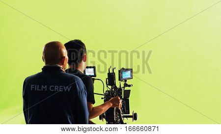 Photographer Team And Film Crew And Movie Camera.