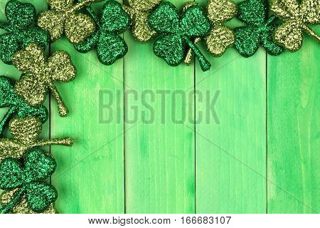 St Patricks Day Corner Border Of Shiny Glitter Shamrocks Over A Green Wood Background