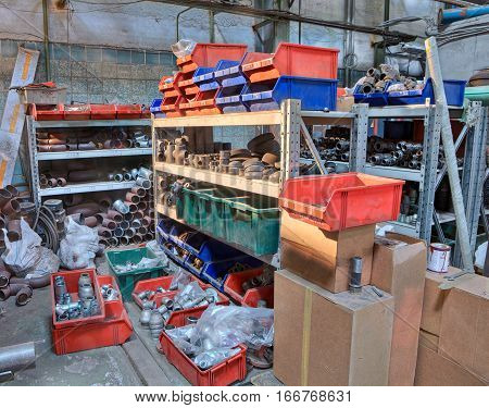St. Petersburg Russia - March 5 2013: Metal plumbing pipe fittings piled up in the box in a stockroom.