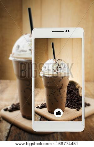 iced mocha with straw in plastic cup on Smartphone