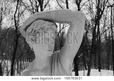Sculpture Of A Girl In Winter Park Covered With Snow.