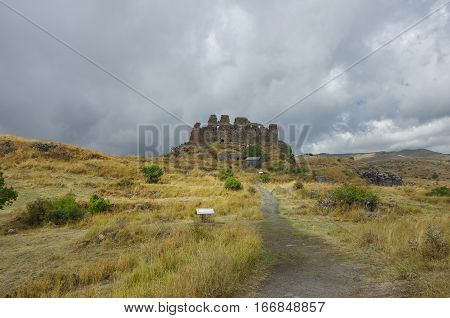 Amberd Fortress  In Slope Of Aragats Mountain In The Clouds. Armenia