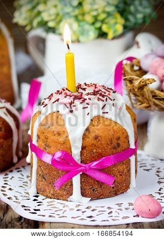 Traditional Easter cake kulich with candle fondant and sprinkle