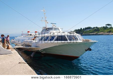 PAXOS, GREECE - JUNE 23, 2014: Joy Cruises hydrofoil ferry Ilida 11 docked at Gaios harbour on the Greek island of Paxos. The 35mtr vessel was built in 1982 in Georgia.