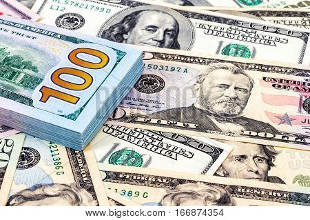 Heap of one hundred american dollar bills close up