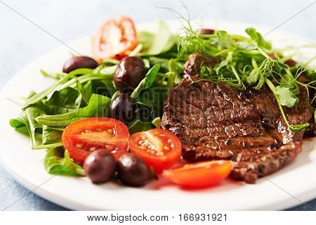 Grilled beef steak with salad and pea sprouts