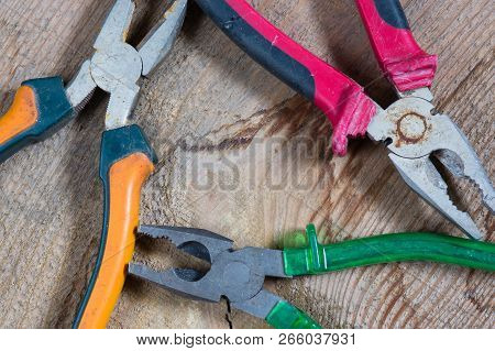 Different Tools On A Wooden Background, Pliers