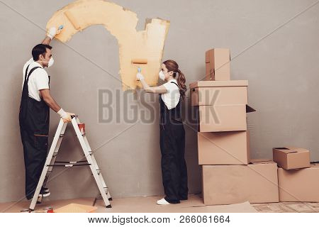 Master Painter. Gray Wall. Cardboard Boxes And Construction Ladder. Man And Woman In Uniform. Master