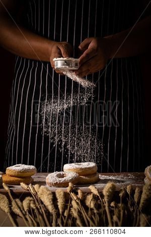 Chef Spreading Flour On Bakery Prepare For Baking. Cook Showing Scatting White Powder Over Raw Homem