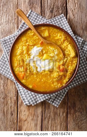 Delicious Tamil Mulligatawny Soup With Lentils, Rice, Chicken, Vegetables And Apple Closeup In A Bow