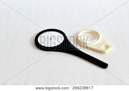 Rare Ophthalmologic Mirror In A Dark Plastic Frame And A Lens For Examining The Fundus On White Gauz