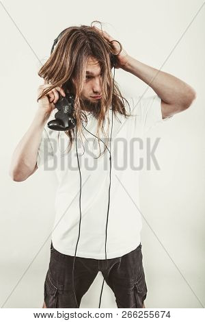 Addiction Effects Concept. Young Unhappy Depressed Man With Pad Joystick Playing Games. Male Addicte