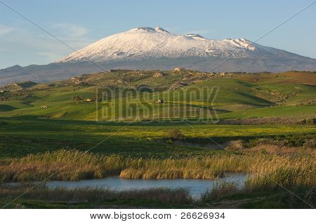 the majestic Etna dominates the green hills of the hinterland of Sicily