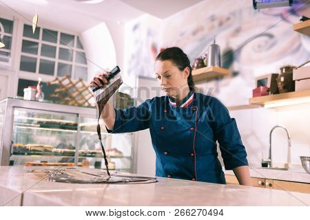 Experienced Female Chocolatier Cooking Amazing Tempered Chocolate
