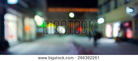 Panorama Of Night Street In Winter. City Light And Glowing Shop Windows. Christmas Sales Concept. Bl