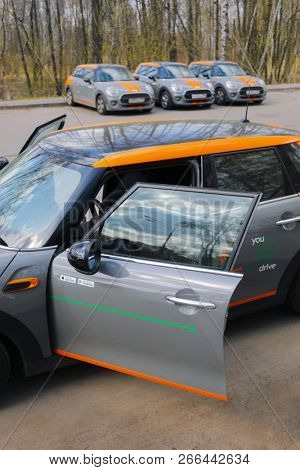 MOSCOW - APR 29, 2018: Four BMW mini cars of Moscow carsharing company You drive outdoor, carsharing is system of short-term car rental, focus on car with opened door