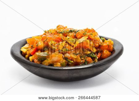 Traditional Colombian Sauce Called Hogao Served In A Black Ceramic Dish Isolated On White Background