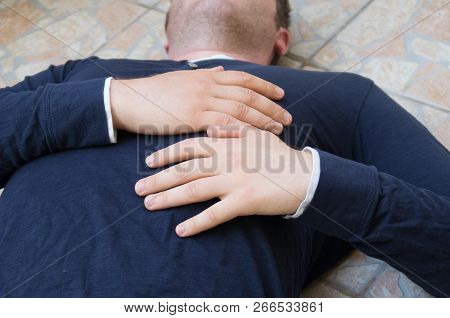 Man With A Heart Attack Lies On The Ground.