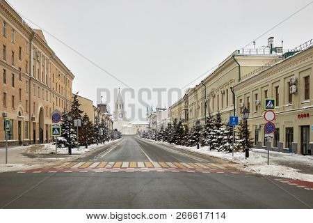 KAZAN, RUSSIA - DEC 10, 2017: Kremlyovskaya street and Spasskaya tower on winter day. Spasskaya Tower of Kazan Kremlin is its main thoroughfare tower and architectural monument of 16th century.