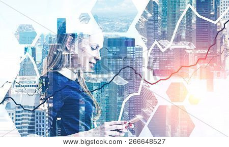 Side View Of Blonde Businesswoman With Smartphone Standing Over Cityscape Background With Digrams In