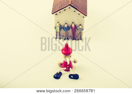 Tiny Figurine Of Men And Puppet Pinocchio Model In View