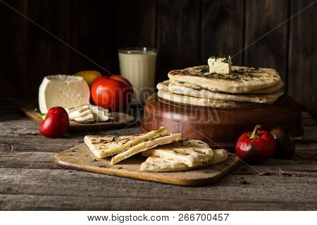 Pita Bread On Wooden Board With Feta Cheese And Tomatoes And Pepper. Still Life Of Food. Georgian Cu