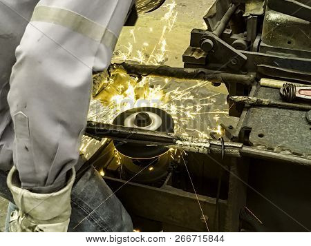 Worker In Factory, Welding And Grinding Steel Wire, Flash Of Fire From Grinding Stone, Metal Industr