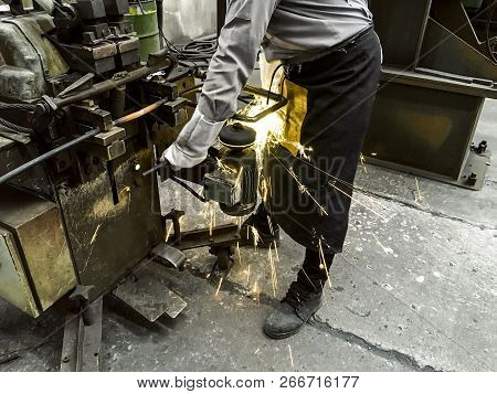 Worker In Factory, Welding And Grinding Steel Wire, Flash Of Fire From Grinding Stone, Metal Industr