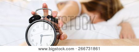 Sleepy Young Woman Trying Kill Alarm Clock While Bury Face In Pillow. Early Wake Up, Not Getting Eno