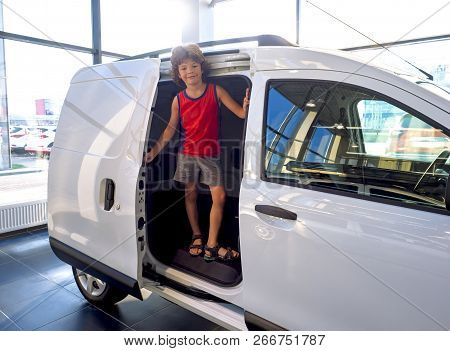 Two Amusing Brunet Little Boy Sitting In A Minibus With A Sliding Door. The Joy Of Buying A New Fami
