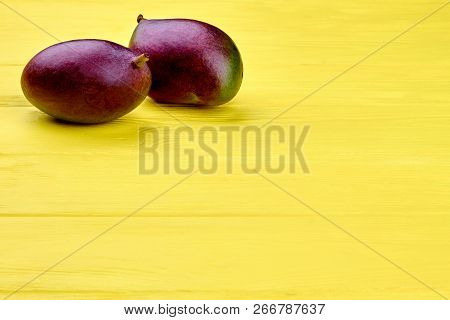 Organic Mango And Copy Space. Fresh Exotic Fruits On Wooden Table With Text Space. Ingredient For Fr