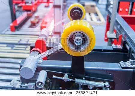 Strapping Machine for Industrail Packaging Line, Modern machine for packaging line in factory, Industrial and technology concept.