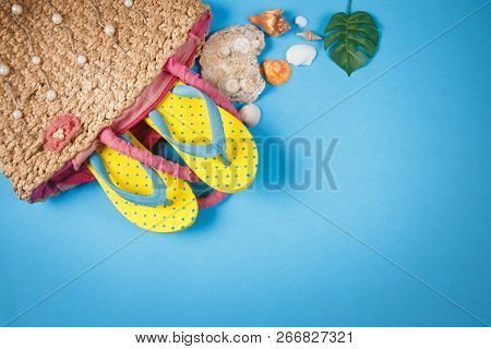 Yellow Sandals With Woven Handbags On Blue Color Background, Summer Holidays Accessories . Flat Lay 