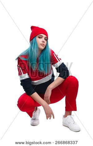 Stylish Modern Young Woman In Red Sportive Outfit And Hat Sitting On Hunkers Isolated On White And L